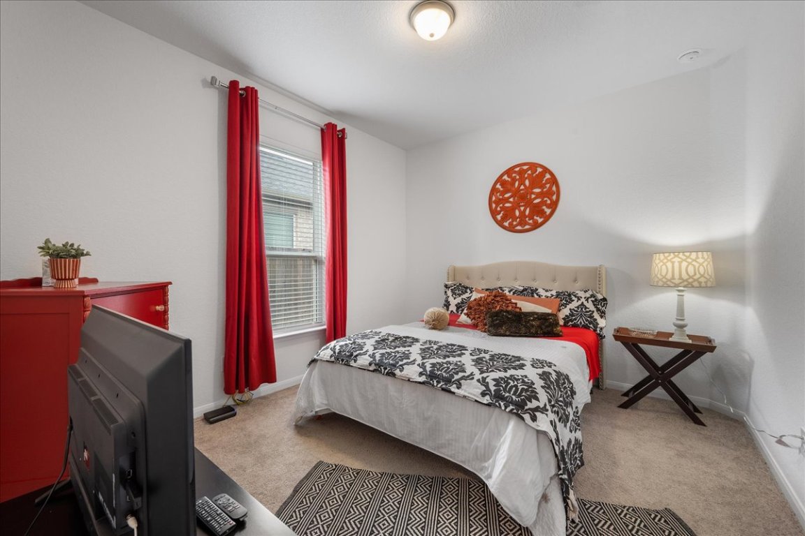 181 Durian Loop Buda, TX 78610 - Photo 17 of 22 a bedroom with a bed and a window