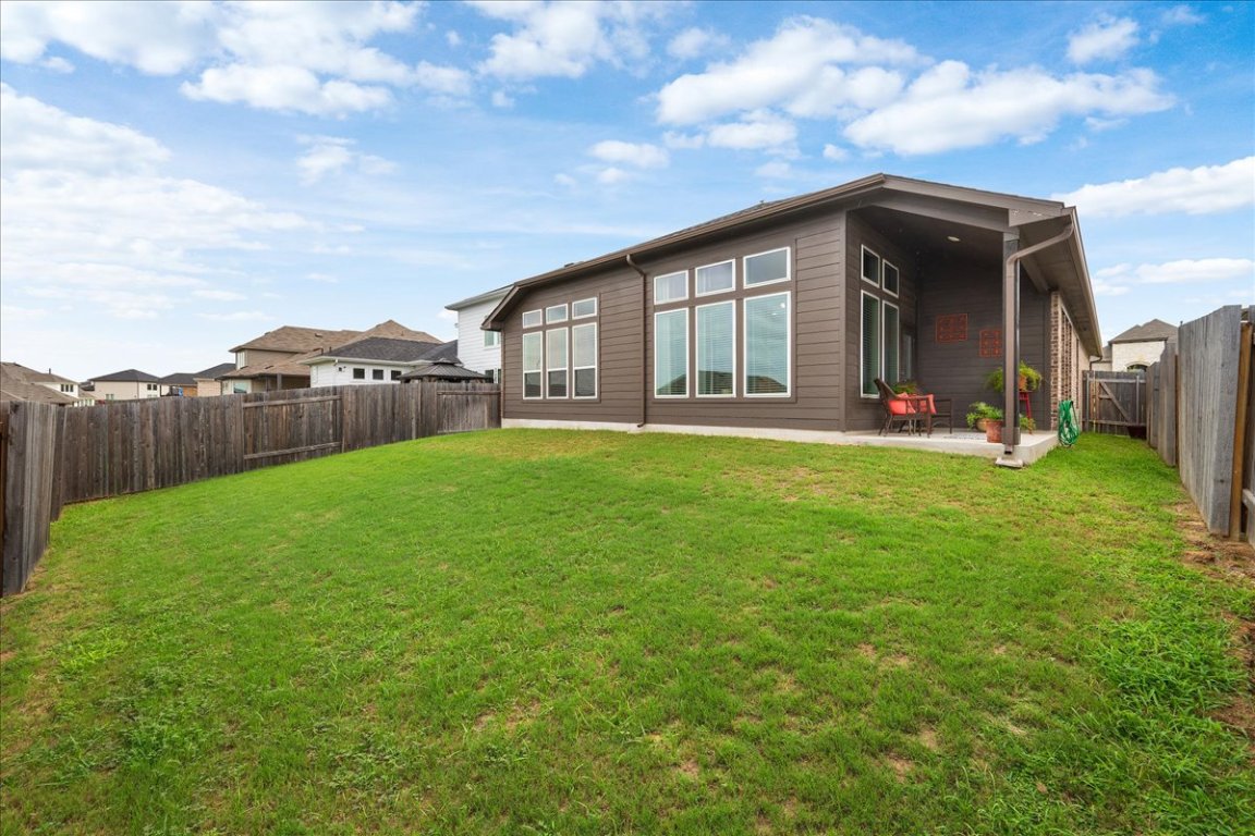 181 Durian Loop Buda, TX 78610 - Photo 21 of 22 a view of a house with a yard and sitting area