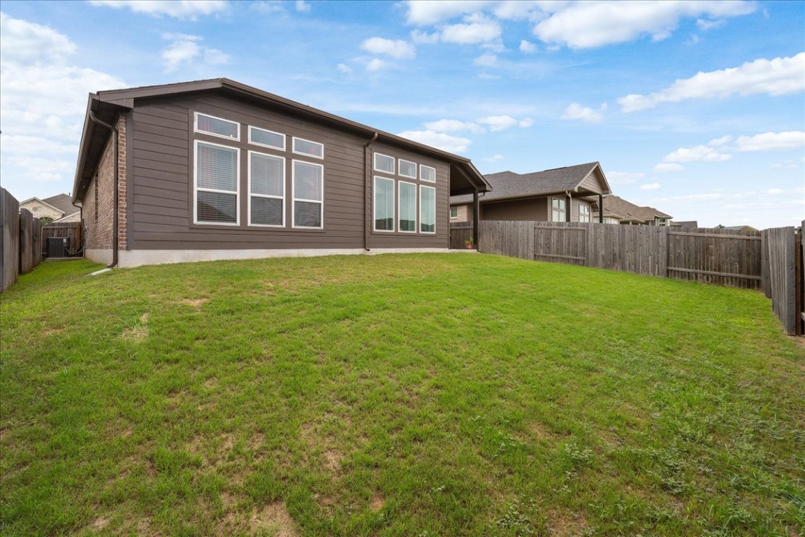 181 Durian Loop Buda, TX 78610 - Photo 22 of 22 a view of a backyard of the house