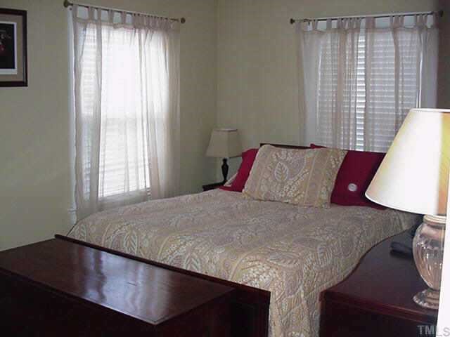 1206 Watauga Street Raleigh, NC 27604 - Photo 7 of 10 a bedroom with a bed and a window