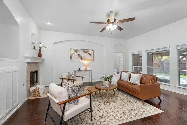 a living room with fireplace furniture and a rug