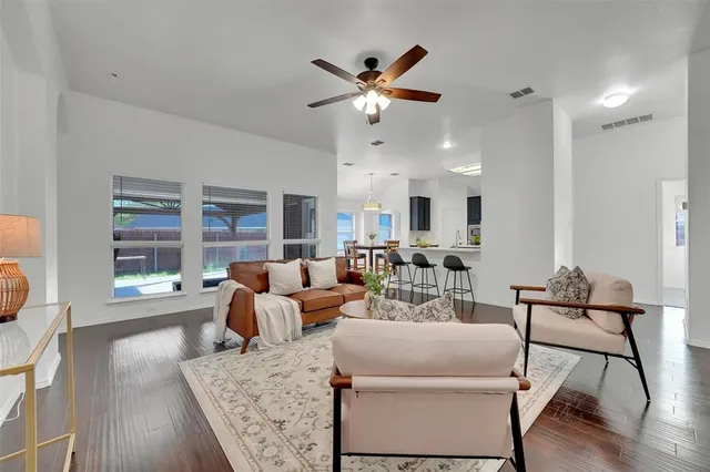 a living room with furniture and a large window