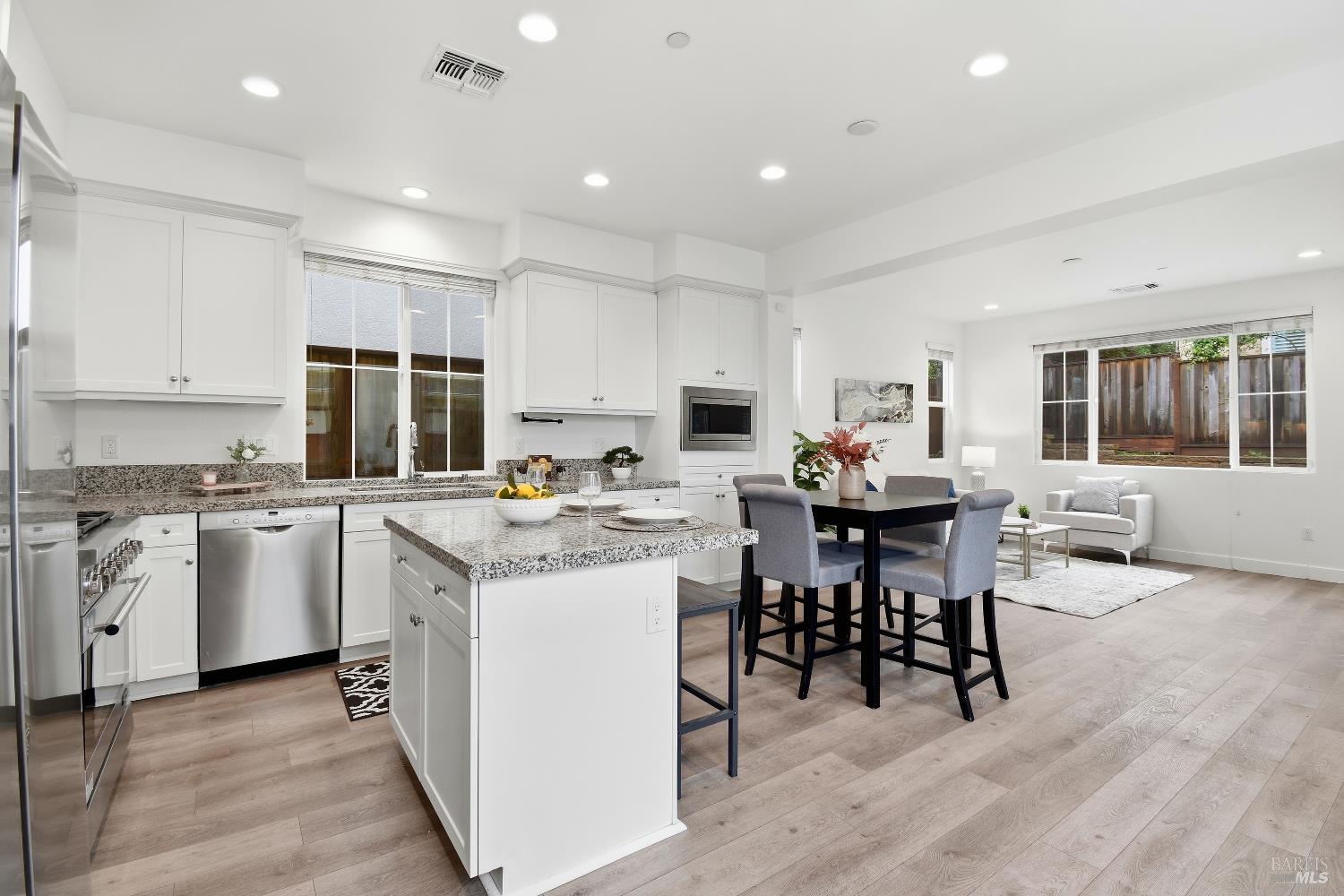 1612 Rose Clover Street Santa Rosa, CA 95403 - Photo 15 of 40 a kitchen that has a lot of white cabinets and stainless steel appliances