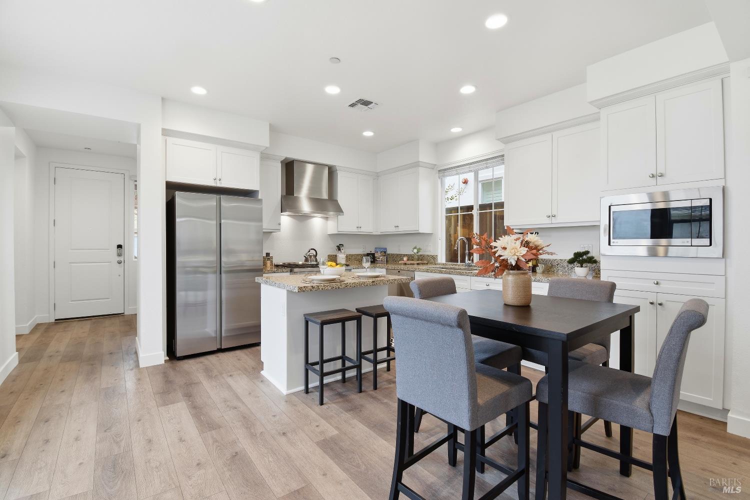 1612 Rose Clover Street Santa Rosa, CA 95403 - Photo 16 of 40 a kitchen with refrigerator and chairs