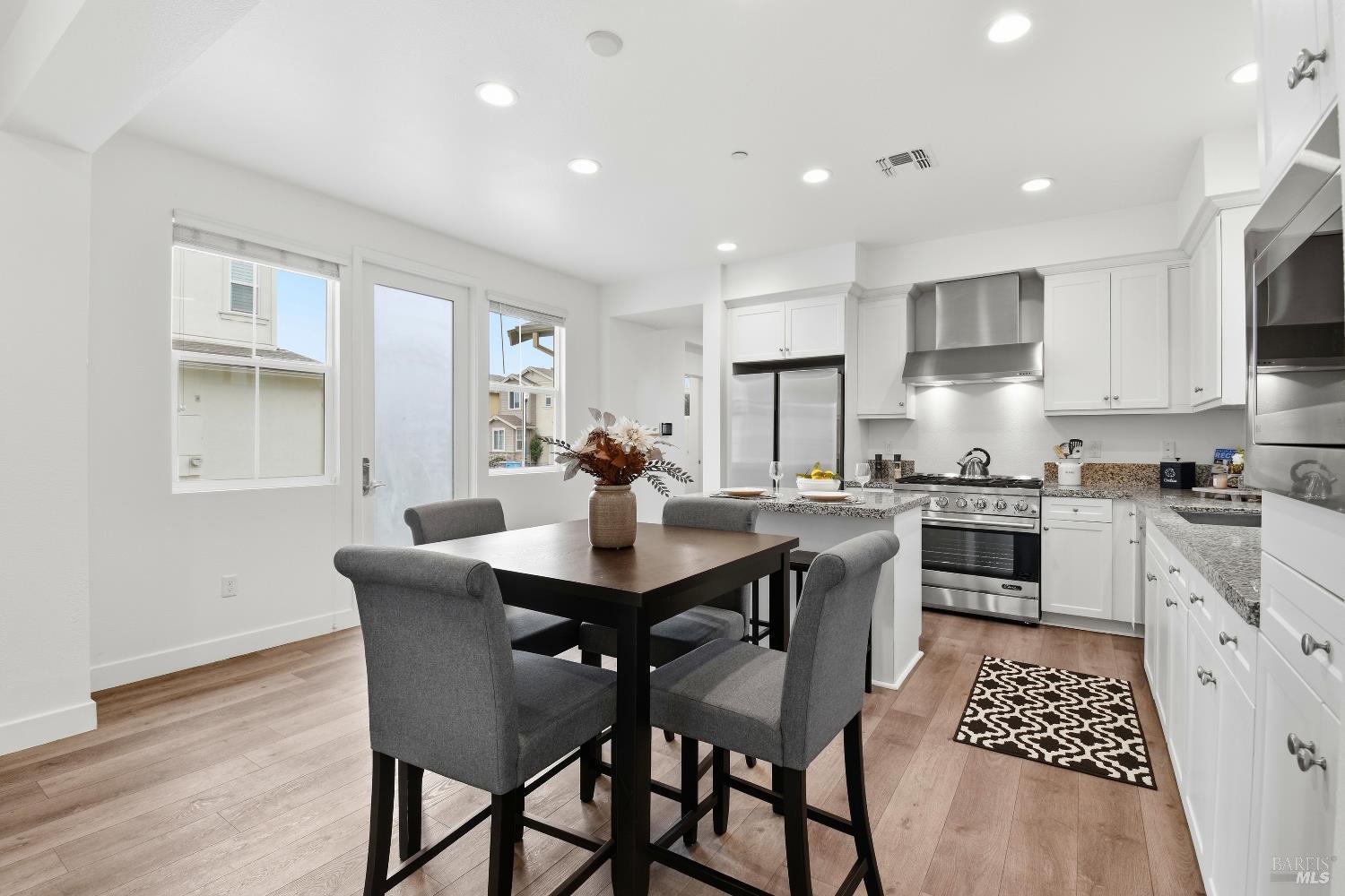 1612 Rose Clover Street Santa Rosa, CA 95403 - Photo 17 of 40 a kitchen with stainless steel appliances kitchen island granite countertop a sink a stove a table and chairs