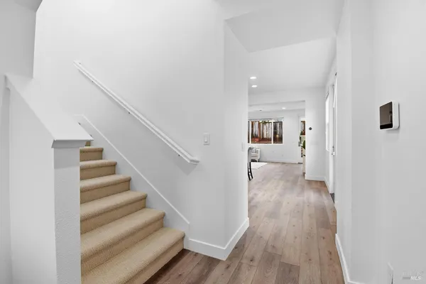 a view of a hallway with wooden floor and entryway