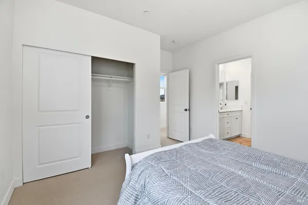 a bedroom with a bed and a mirror