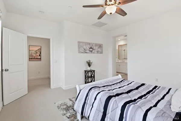 a bedroom with a large bed and a chandelier