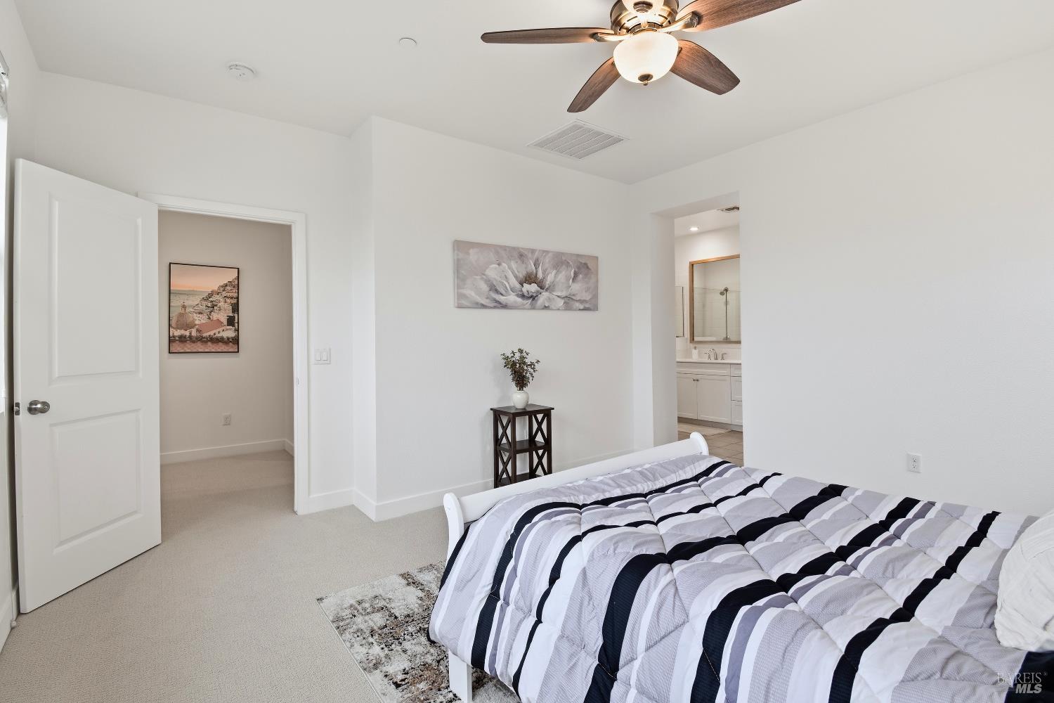 1612 Rose Clover Street Santa Rosa, CA 95403 - Photo 25 of 40 a bedroom with a large bed and a chandelier