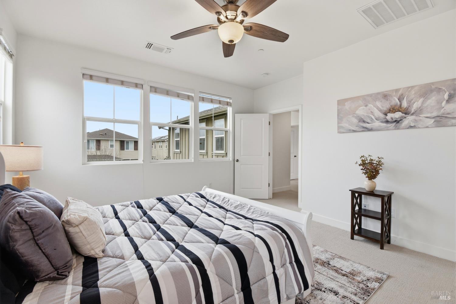 1612 Rose Clover Street Santa Rosa, CA 95403 - Photo 26 of 40 a bedroom with a bed and a chandelier