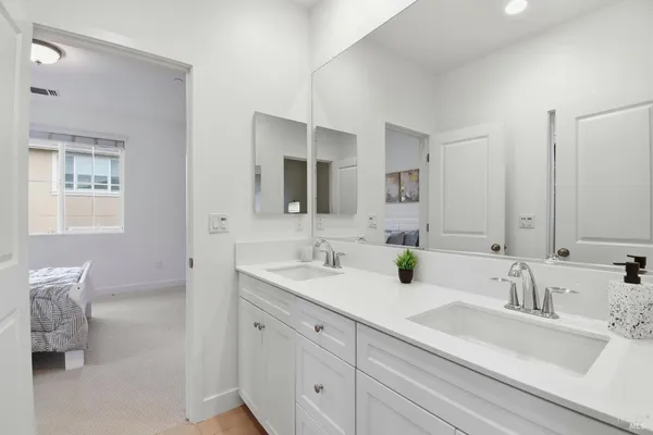 a bathroom with 2 sink tub and a mirror