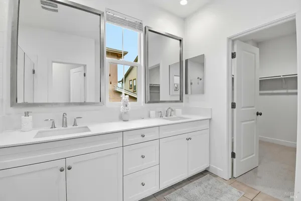 a bathroom with a double vanity sink and mirror