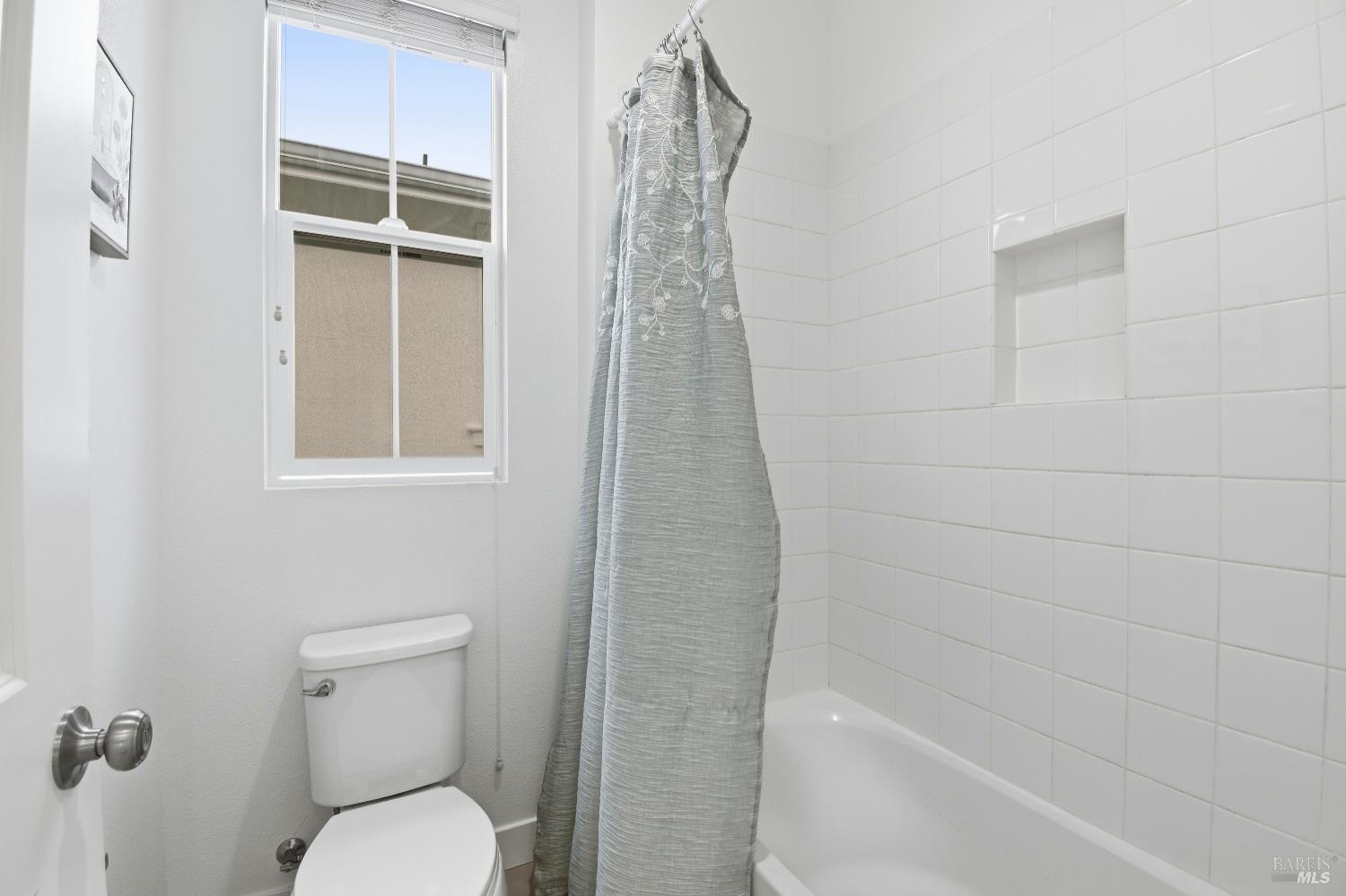 1612 Rose Clover Street Santa Rosa, CA 95403 - Photo 33 of 40 a bathroom with a shower a toilet and a window