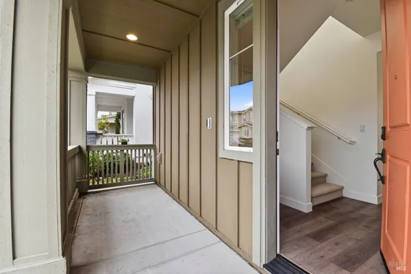 a view of a hallway with a livingroom and entryway
