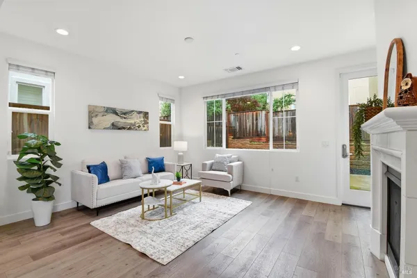 a living room with furniture fireplace and window