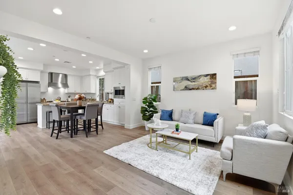 a living room with furniture and kitchen view