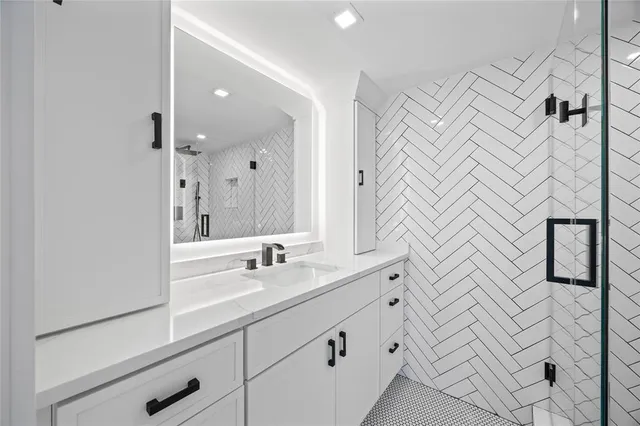 a bathroom with a double vanity sink mirror and