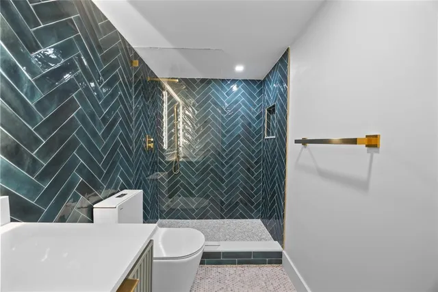 a bathroom with a toilet and shower