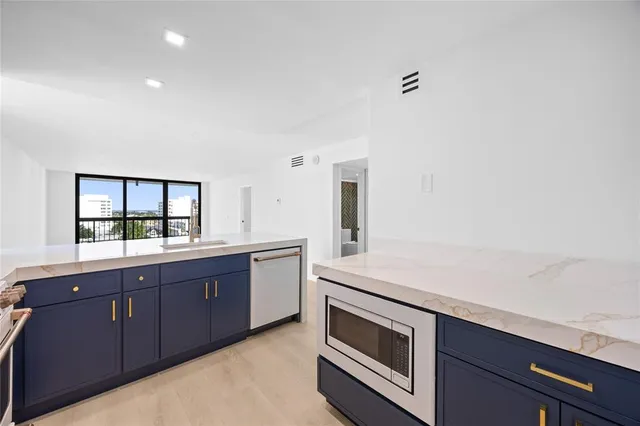 a kitchen with stainless steel appliances granite countertop a stove and a sink
