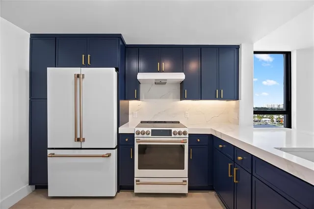 a kitchen with a stove and a refrigerator