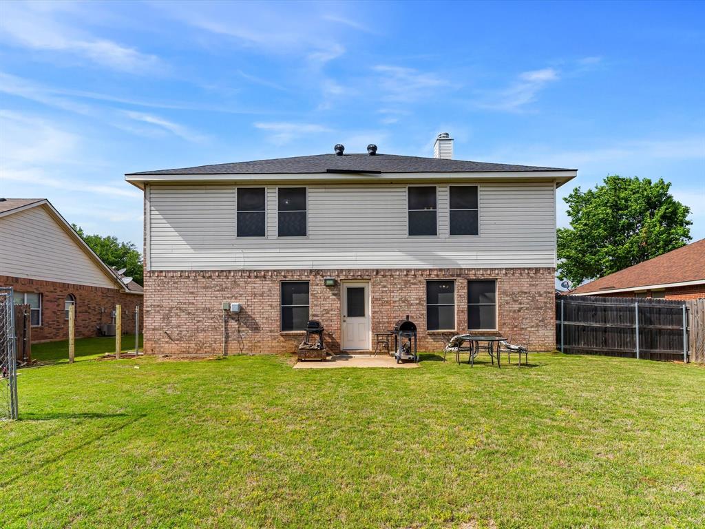 1129 Switchgrass Lane Crowley, TX 76036 - Photo 33 of 40 a front view of a house with patio