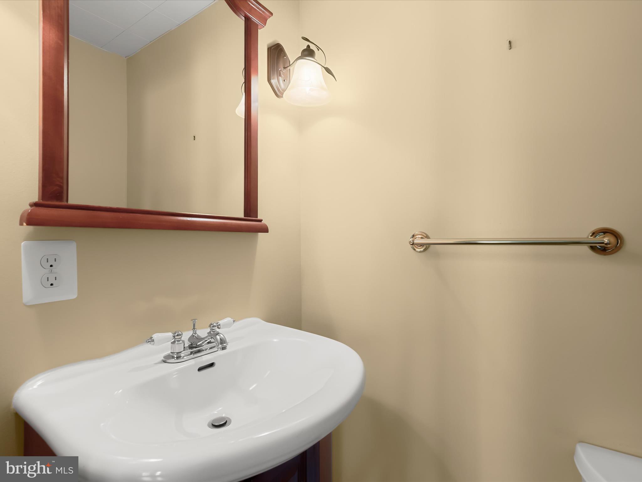 1229-7 Seven Oaks Road Halethorpe, MD 21227 - Photo 23 of 38 a bathroom with a sink and mirror