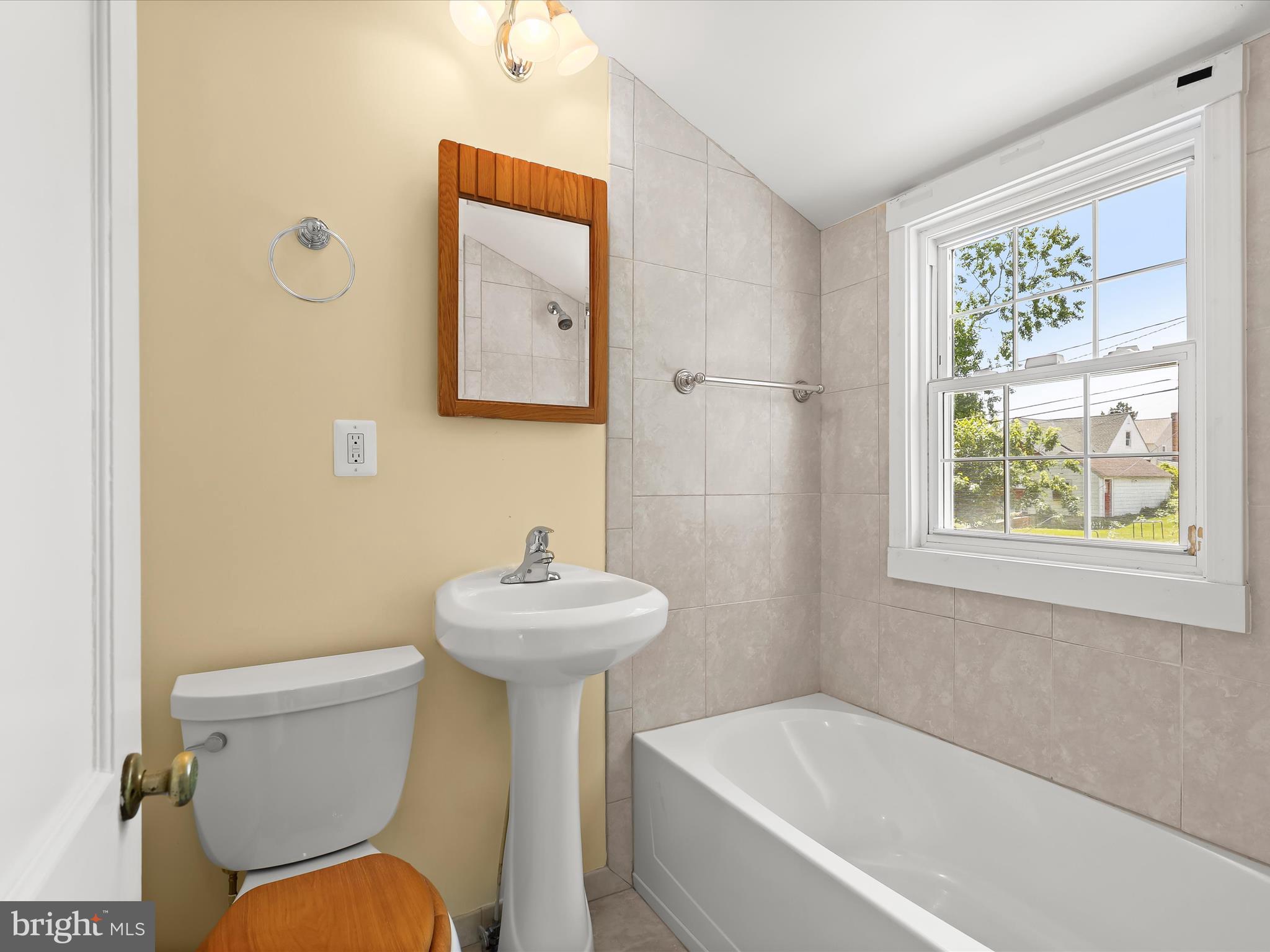 1229-7 Seven Oaks Road Halethorpe, MD 21227 - Photo 24 of 38 a white toilet sitting next to a bathroom sink