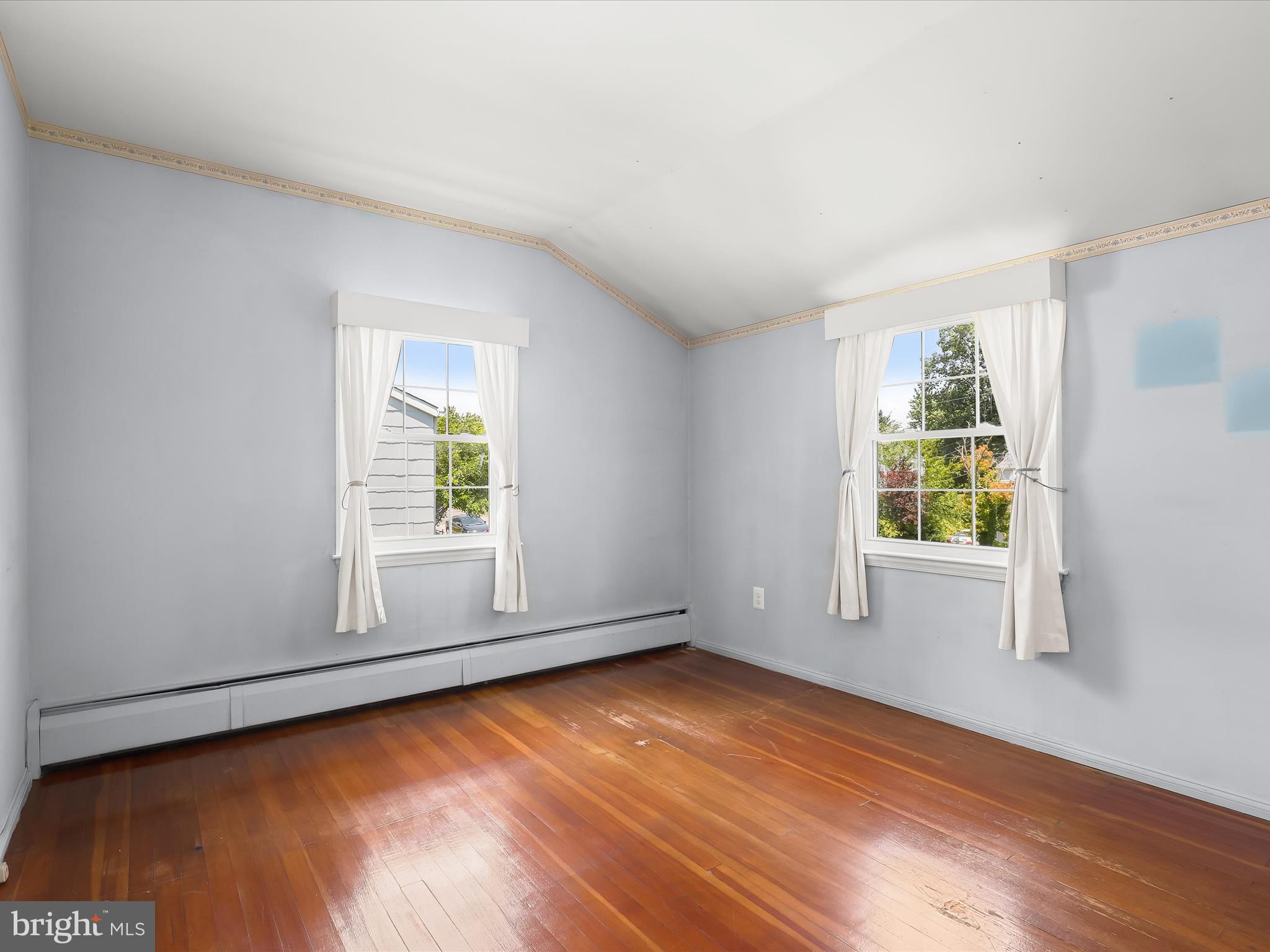 1229-7 Seven Oaks Road Halethorpe, MD 21227 - Photo 25 of 38 an empty room with wooden floor and windows