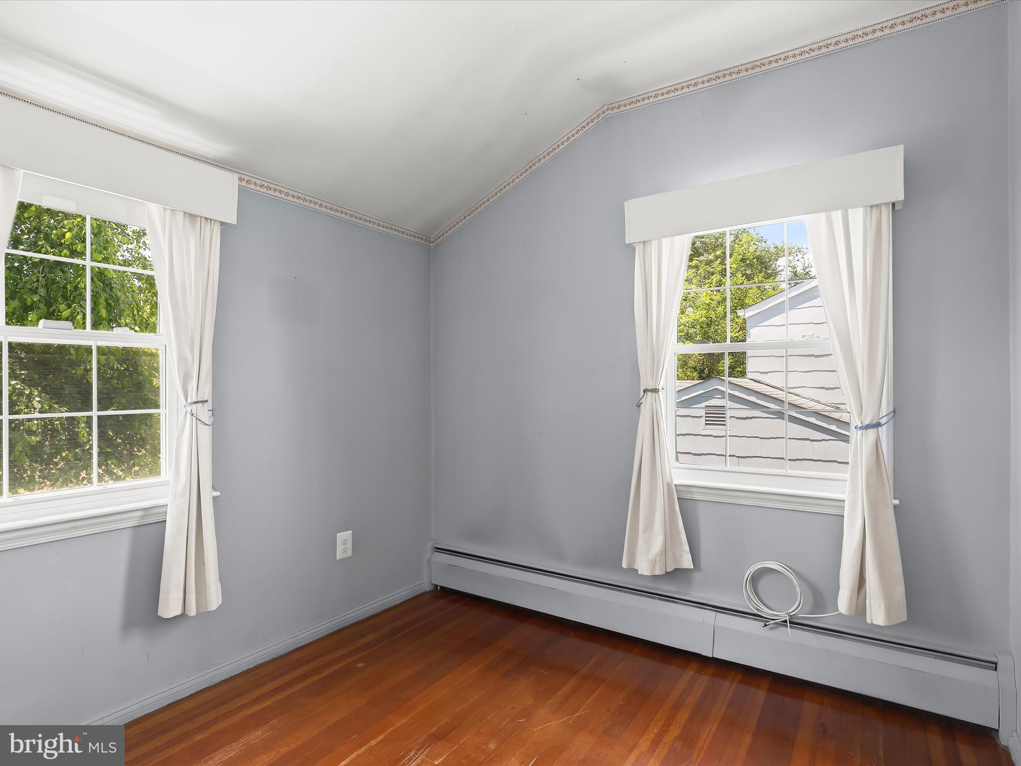 1229-7 Seven Oaks Road Halethorpe, MD 21227 - Photo 27 of 38 a view of empty room with wooden floor and fan