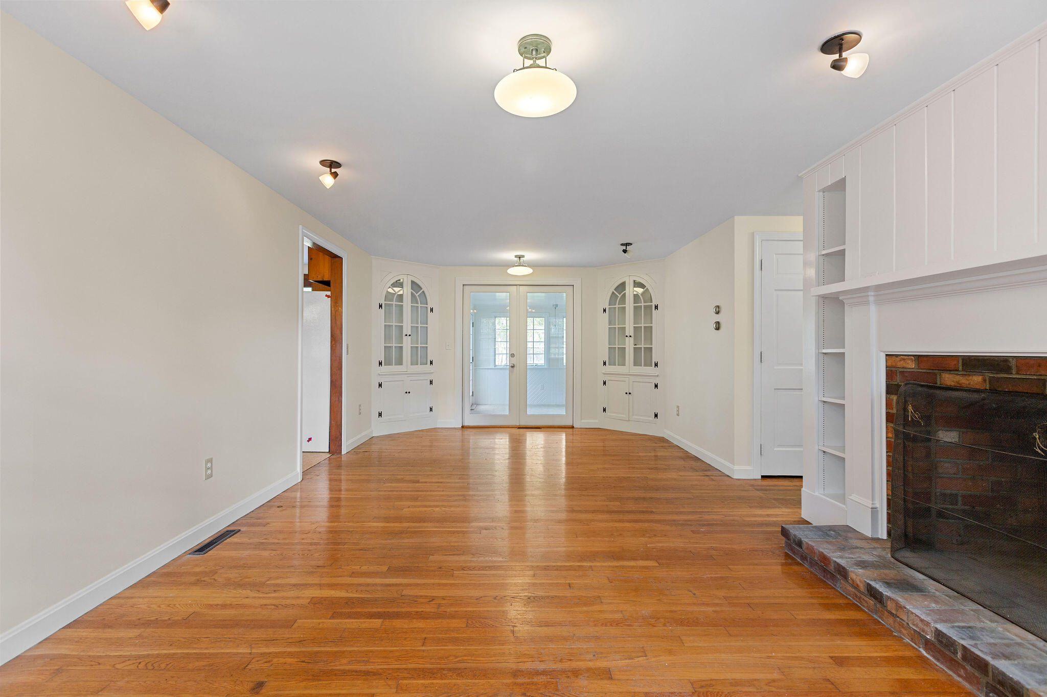 44 Beriah Brooks Road Harwich, MA 02645 - Photo 13 of 43 an empty room with windows and fireplace