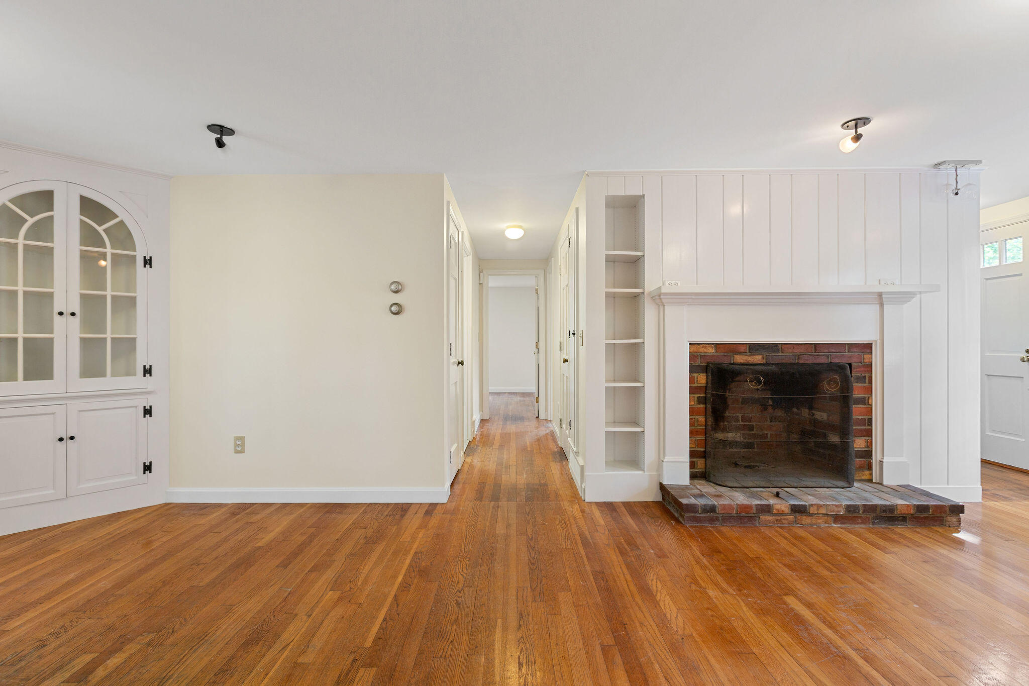 44 Beriah Brooks Road Harwich, MA 02645 - Photo 16 of 43 an empty room with wooden floor and fireplace