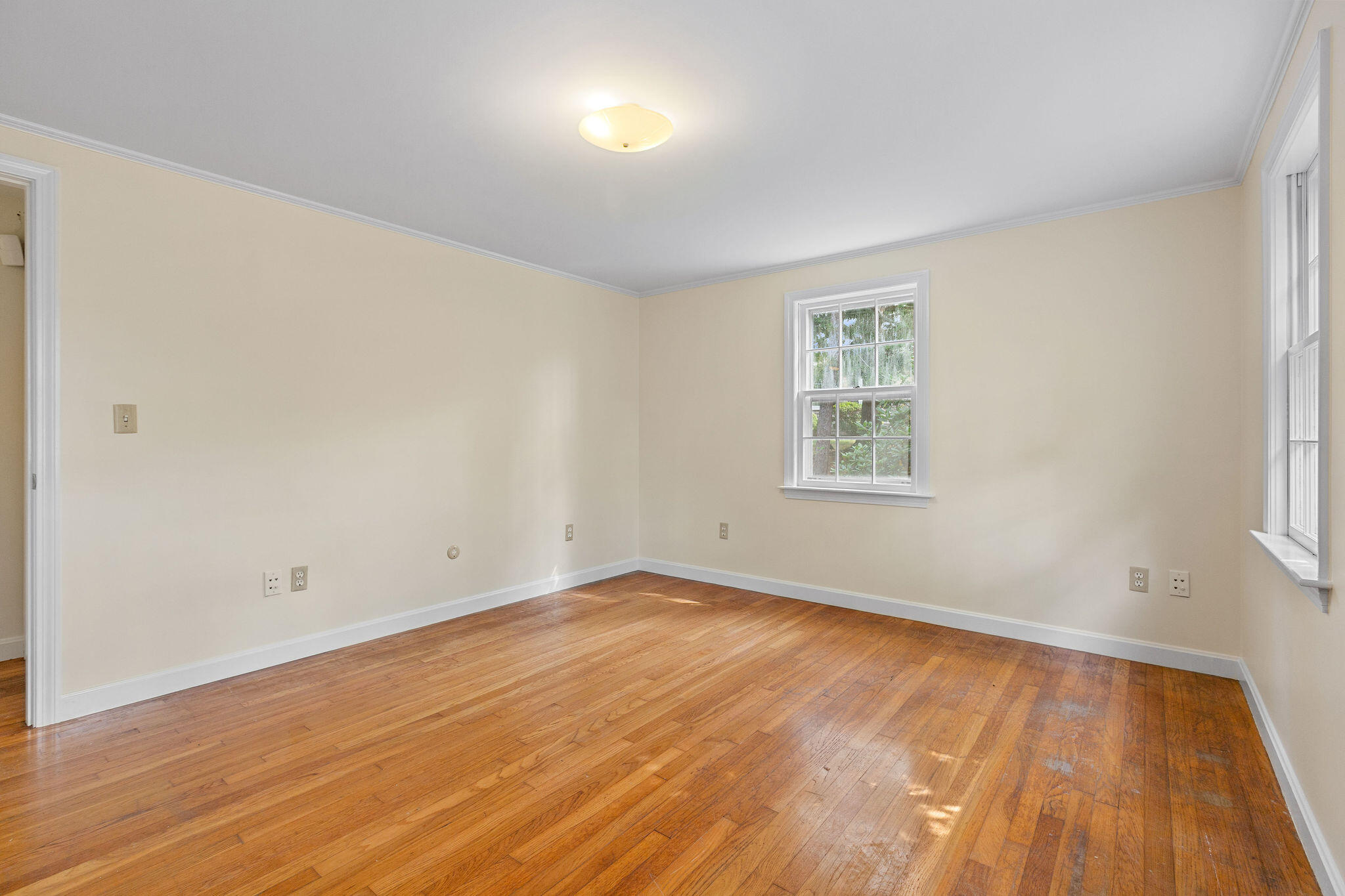 44 Beriah Brooks Road Harwich, MA 02645 - Photo 29 of 43 an empty room with wooden floor and windows