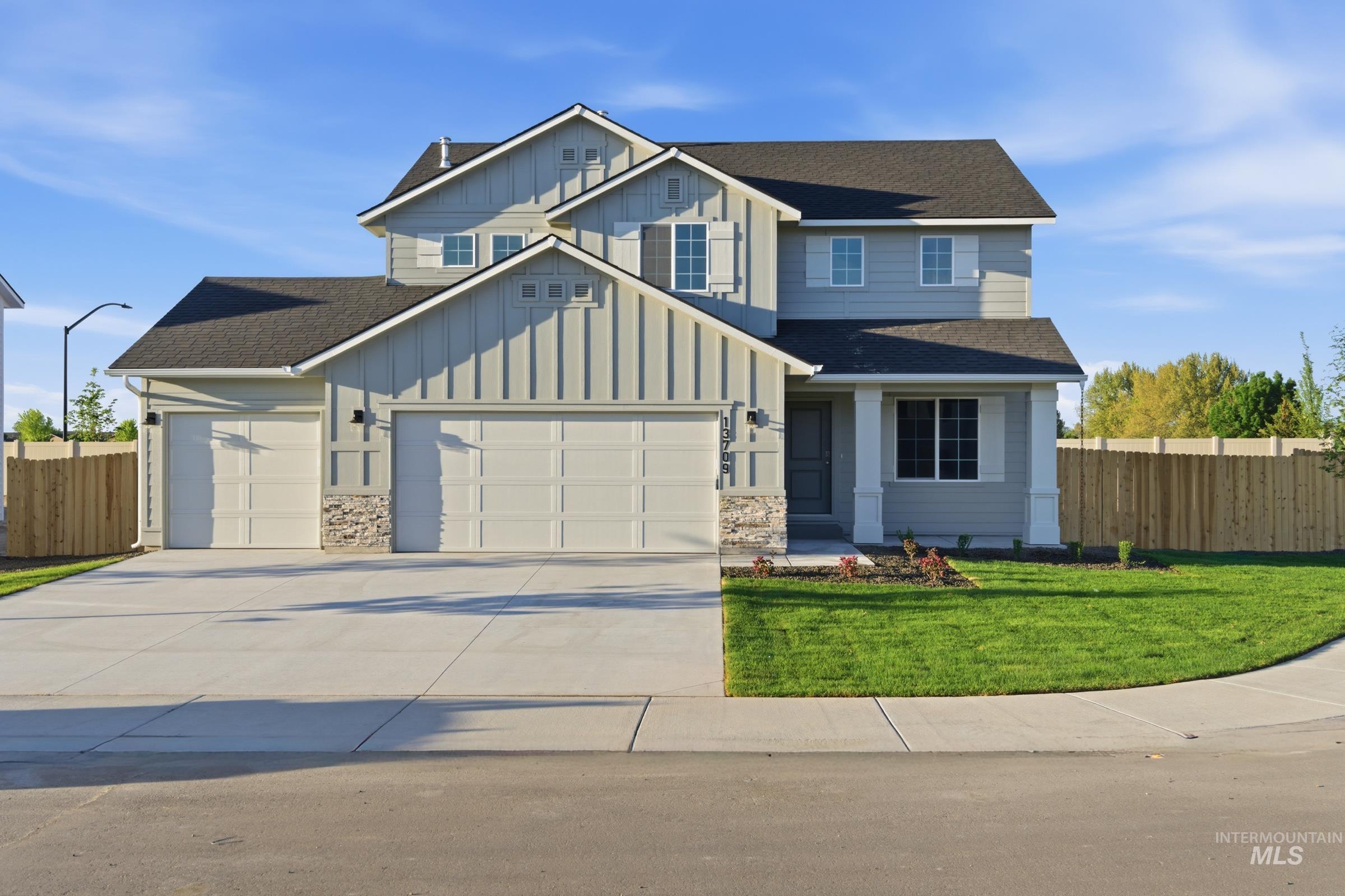 13709 Redway Court Caldwell, ID 83607 - Photo 1 of 28 Two-story residence featuring light gray siding, board and batten accents, and stone detailing