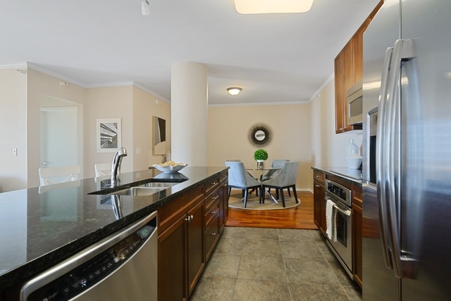 807 Davis Street, Unit 1504 Evanston, IL 60201 - Photo 3 of 14 a kitchen with granite countertop a sink stove and refrigerator