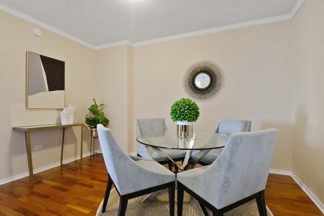 807 Davis Street, Unit 1504 Evanston, IL 60201 - Photo 6 of 14 a view of a dining room with furniture and wooden floor