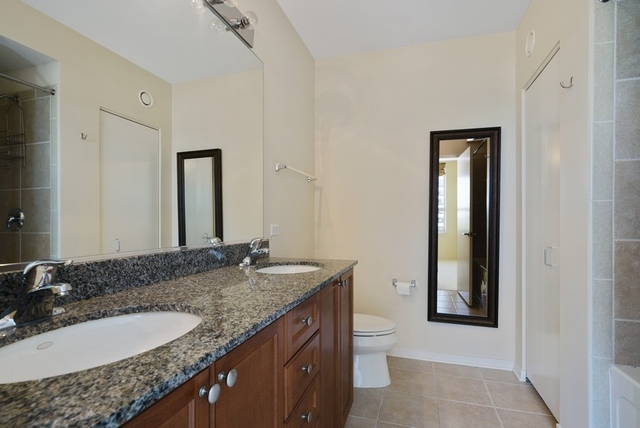 807 Davis Street, Unit 1504 Evanston, IL 60201 - Photo 9 of 14 a bathroom with a granite countertop sink and a mirror