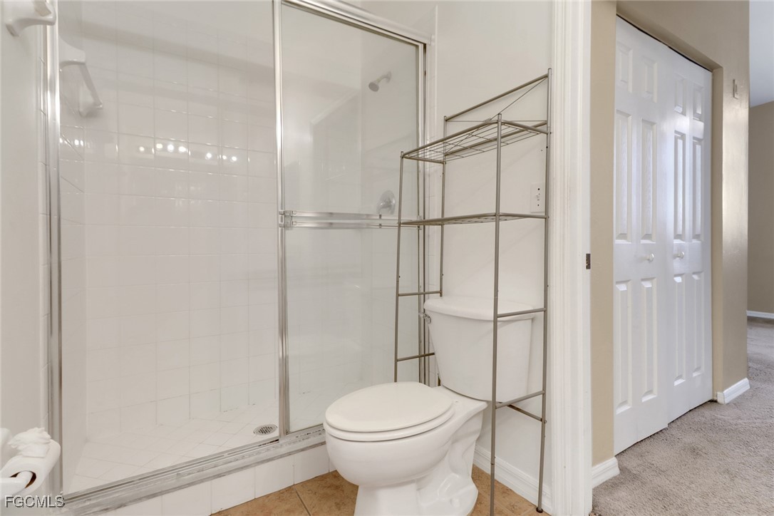 4214 Bellasol Circle, Unit 824 Fort Myers, FL 33916 - Photo 13 of 27 a bathroom with a toilet and a shower