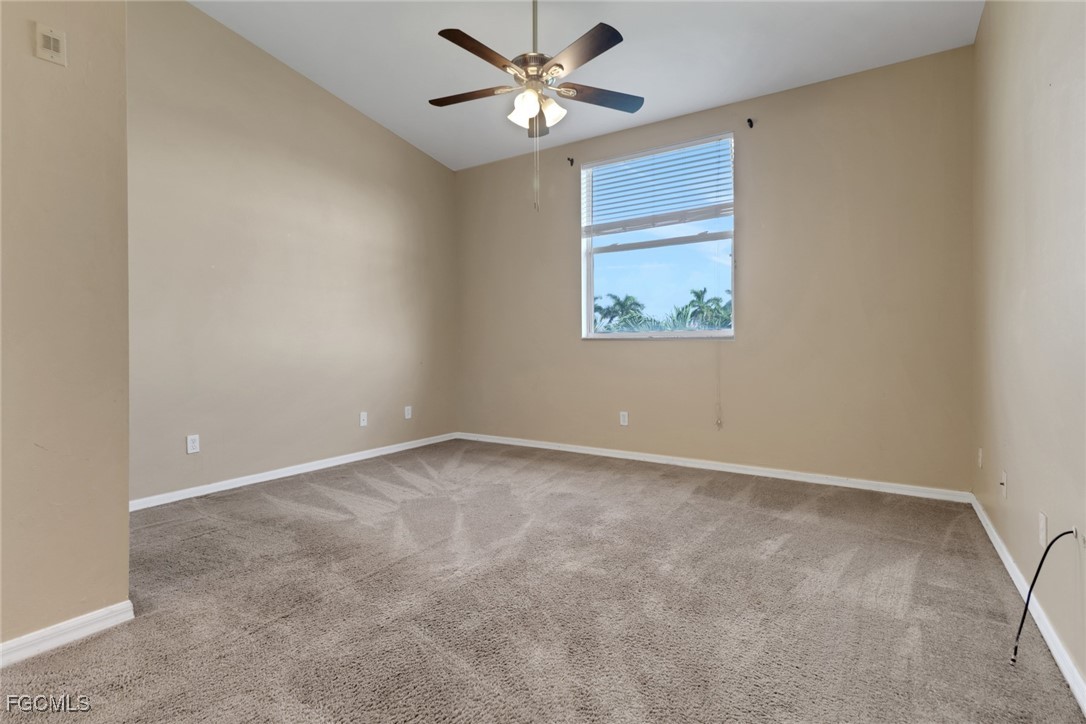 4214 Bellasol Circle, Unit 824 Fort Myers, FL 33916 - Photo 14 of 27 an empty room with a window and a fan