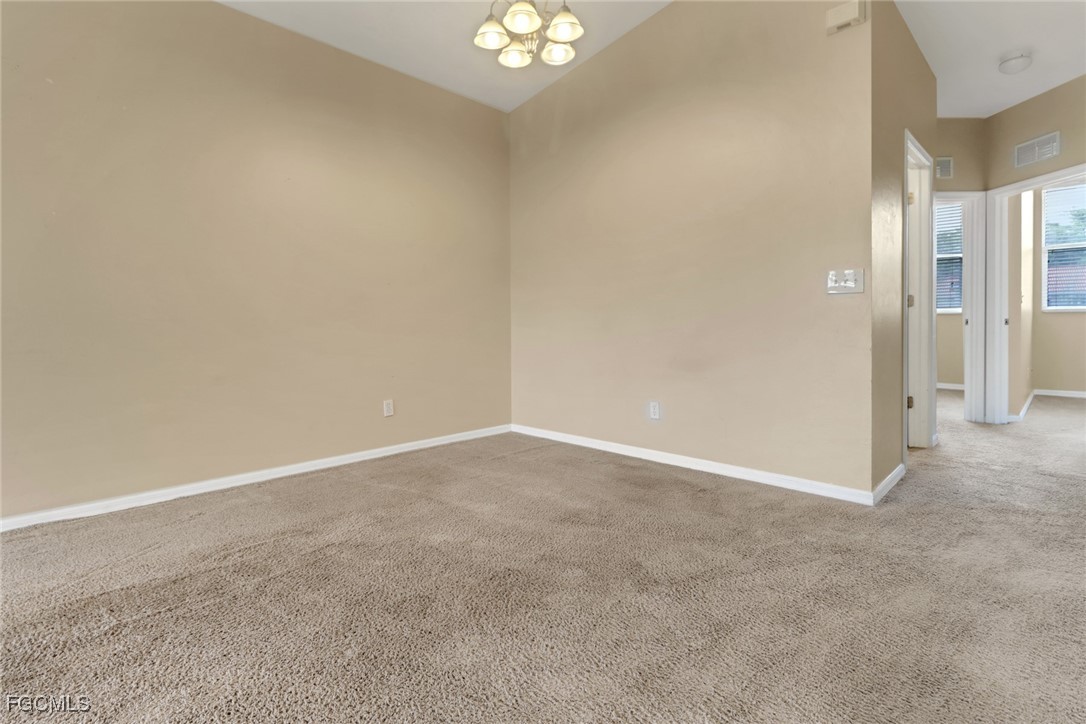 4214 Bellasol Circle, Unit 824 Fort Myers, FL 33916 - Photo 18 of 27 a view of an empty room and a chandelier fan