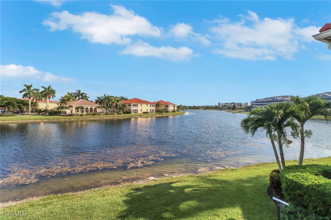 4214 Bellasol Circle, Unit 824 Fort Myers, FL 33916 - Photo 2 of 27 a view of a lake with houses in the background