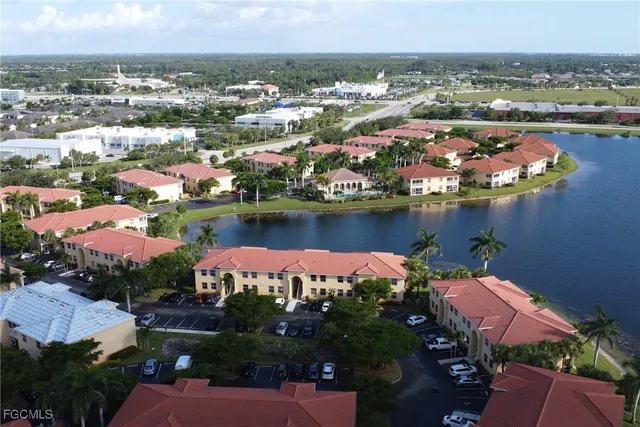 an aerial view of a houses with a lake view