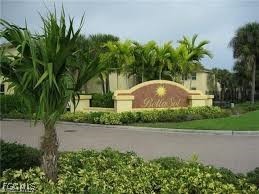4214 Bellasol Circle, Unit 824 Fort Myers, FL 33916 - Photo 26 of 27 a front view of a house with a yard and a garage