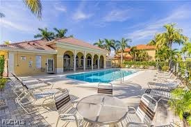 4214 Bellasol Circle, Unit 824 Fort Myers, FL 33916 - Photo 27 of 27 a view of a white house with a swimming pool and outdoor seating