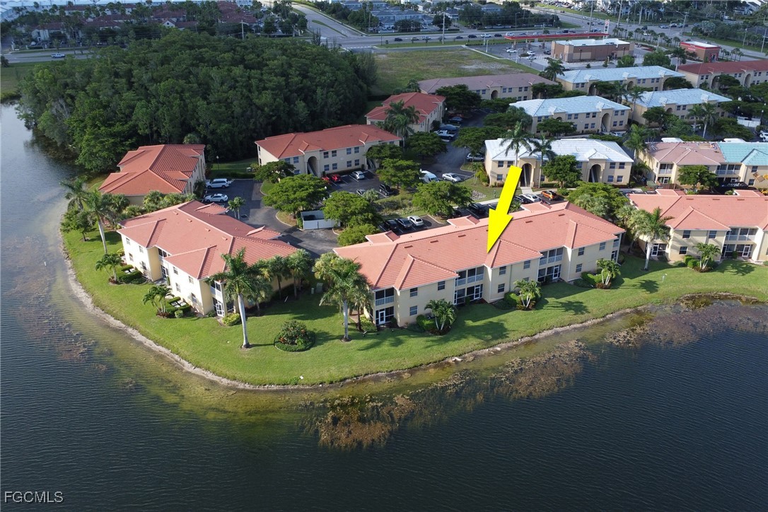 4214 Bellasol Circle, Unit 824 Fort Myers, FL 33916 - Photo 3 of 27 an aerial view of residential houses with outdoor space and lake view