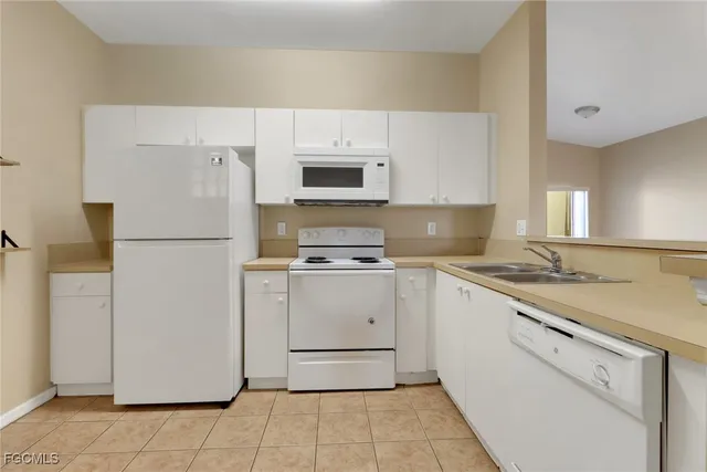 a kitchen with a refrigerator sink and microwave