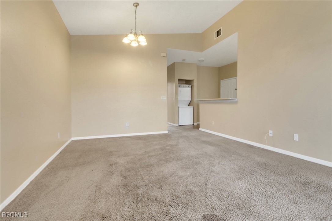 4214 Bellasol Circle, Unit 824 Fort Myers, FL 33916 - Photo 8 of 27 a view of an empty room with a chandelier fan