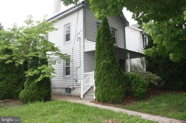 a view of a house with a yard and sitting area