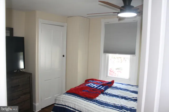 a bedroom with a bed and a window