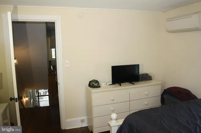 a hotel room with a bed and television