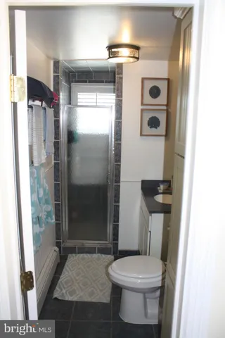 a bathroom with a toilet and a shower